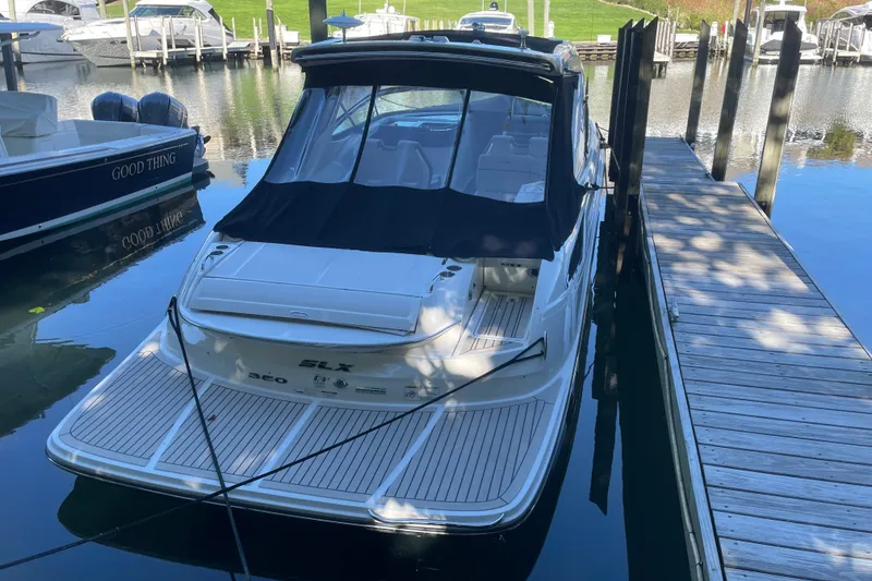 Slide: The Image of 2015 Sea Ray SLX 350 boat docked at marina with black canopy. - 3