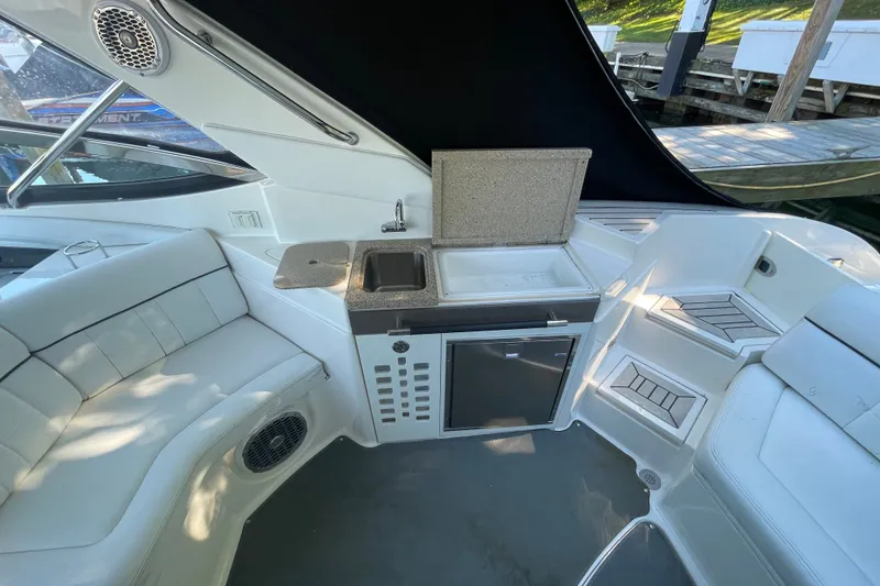 Slide: The Image of Interior of 2015 Sea Ray SLX 350 boat with seating and kitchenette area. - 11