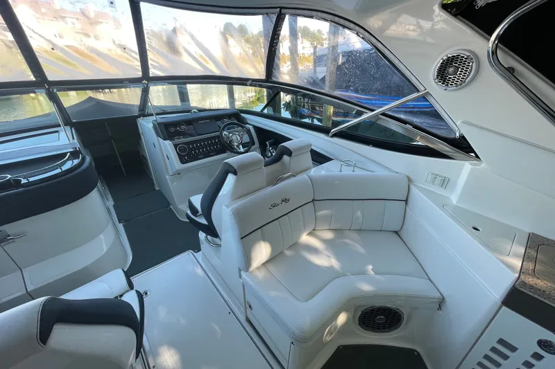 Slide: The Image of Interior of a 2015 Sea Ray SLX 350 boat with luxurious seating and modern dashboard. - 9