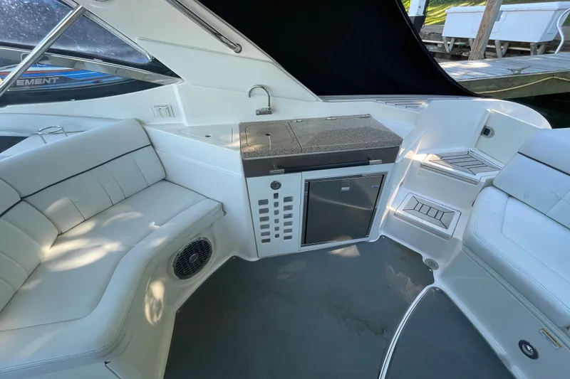 Slide: The Image of Interior of 2015 Sea Ray SLX 350 boat with seating and kitchenette area. - 10