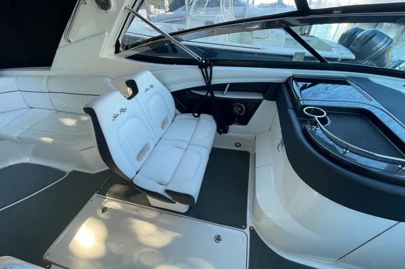Slide: The Image of Interior of a 2015 Sea Ray SLX 350 boat with white seating and sleek design. - 14