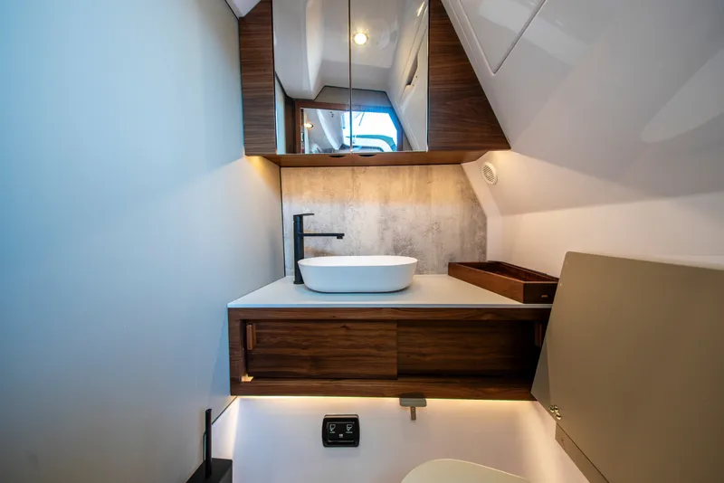 Slide: The Image of Modern bathroom interior of 2027 Axopar 38 Cross Cabin with sleek design elements. - 38