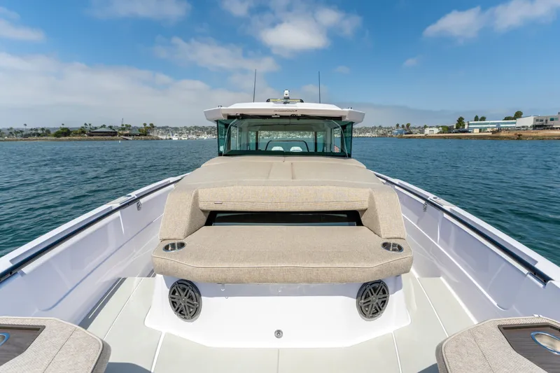 Slide: The Image of 2027 Axopar 38 Cross Cabin boat on water, featuring spacious seating and modern design. - 14