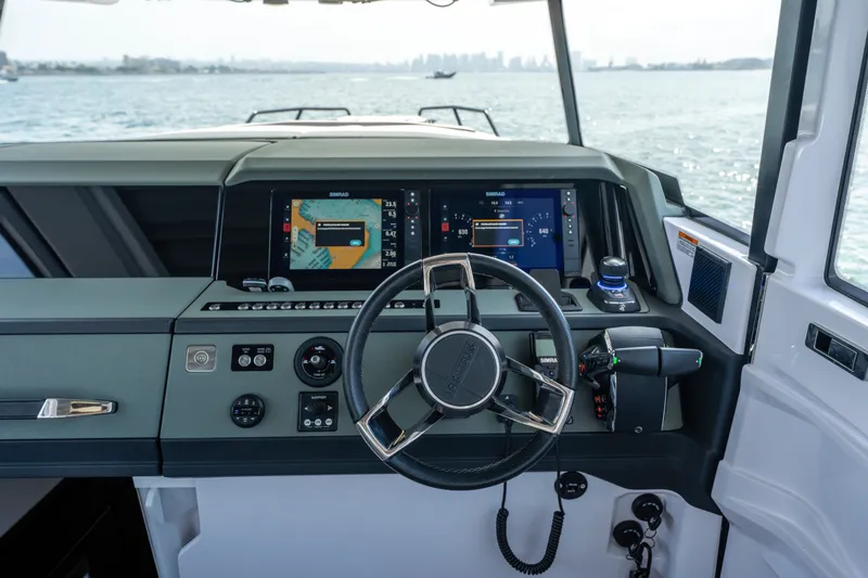 Slide: The Image of Helm of 2027 Axopar 38 Cross Cabin with advanced navigation displays and controls. - 27
