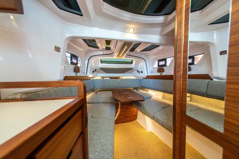 Slide: The Image of Luxurious interior of 2027 Axopar 38 Cross Cabin with modern seating and wood accents. - 31