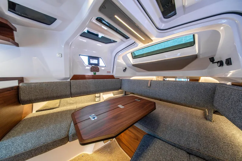 Slide: The Image of Interior of 2027 Axopar 38 Cross Cabin, featuring modern seating and wooden table. - 36