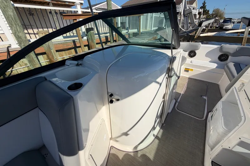 Slide: The Image of 2021 NauticStar 223 DC boat interior with seating and cup holders. - 17