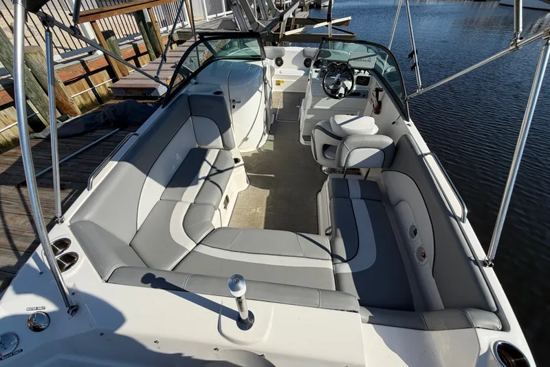 Slide: The Image of 2021 NauticStar 223 DC boat interior with gray seating and steering wheel. - 8