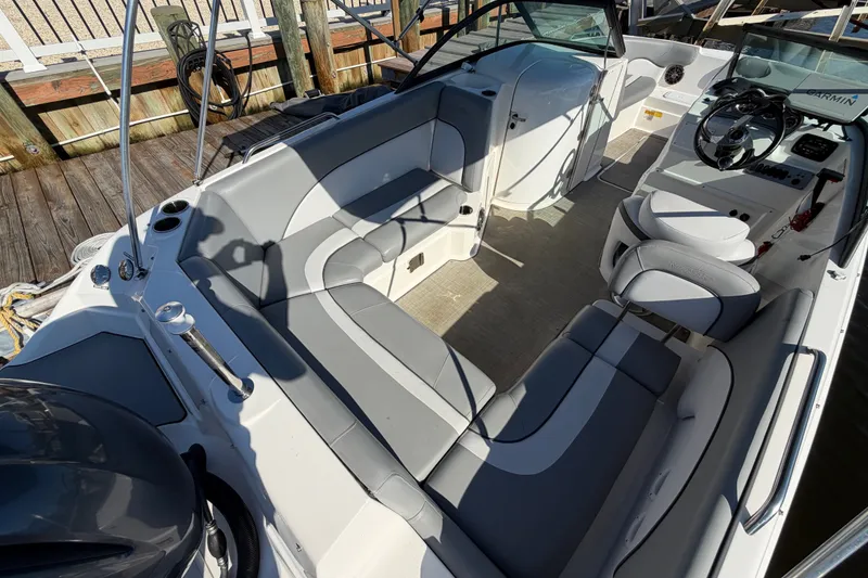 Slide: The Image of 2021 NauticStar 223 DC boat interior with gray seating and steering console. - 9