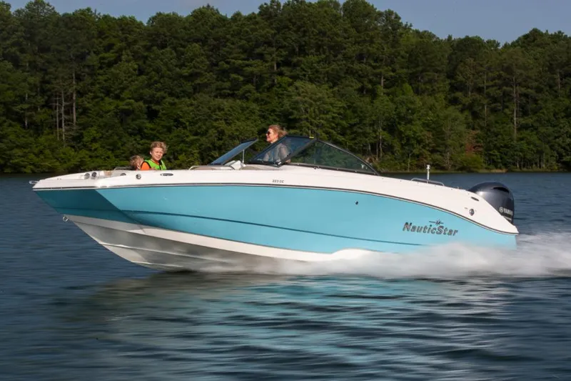 The Image of Manufacturer Provided Image: 2021 NauticStar 223 DC boat cruising on a lake with passengers. - 0