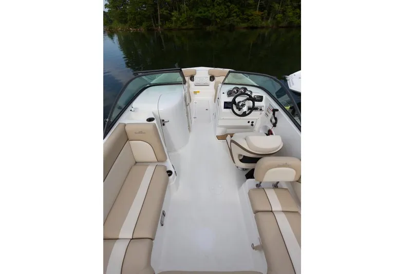 Slide: The Image of Manufacturer Provided Image: 2021 NauticStar 223 DC boat interior with beige seating and steering console. - 2