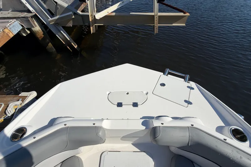 Slide: The Image of Bow view of 2021 NauticStar 223 DC boat docked on calm water. - 20