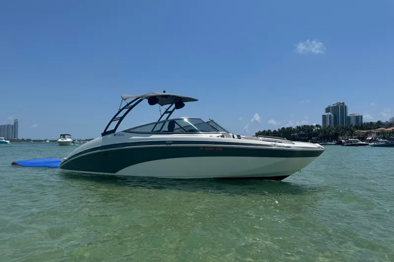 The Image of 2015 Yamaha Boats 242 Limited S in clear waters, with city skyline in background. - 0