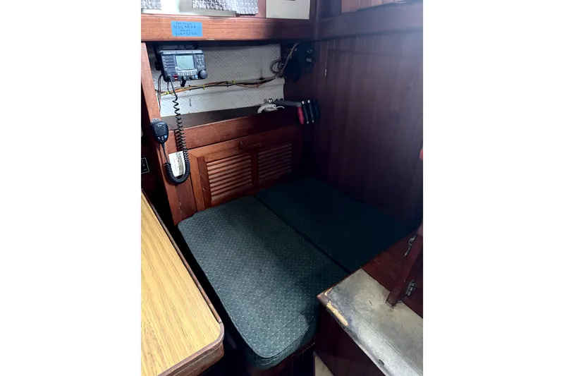 Slide: The Image of 1979 Tayana 37 sailboat interior with navigation equipment and seating area. - 13