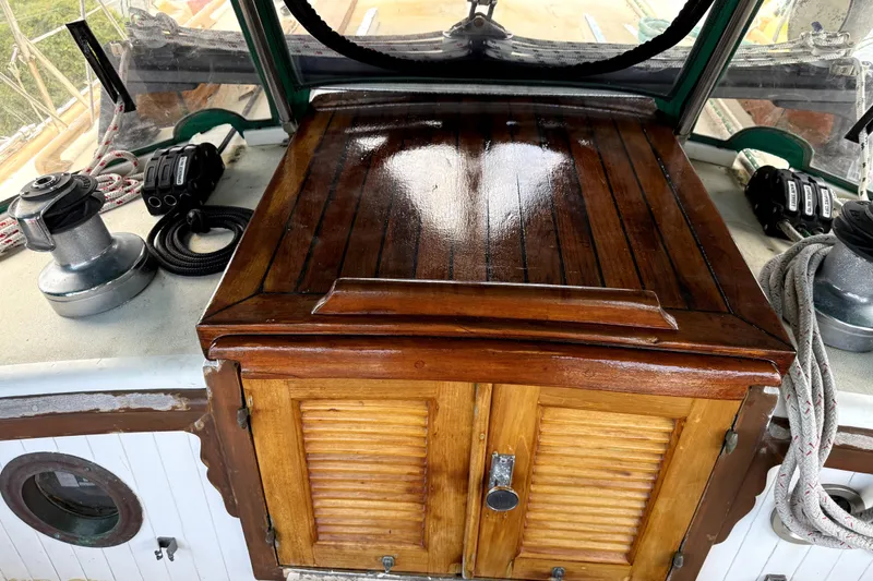 Slide: The Image of Polished wooden hatch on 1979 Tayana 37 sailboat deck, with winches and ropes. - 24