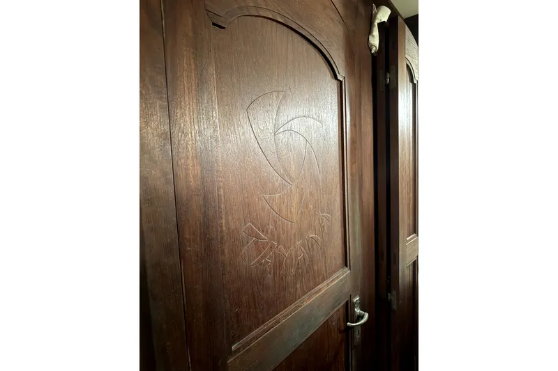 Slide: The Image of Wooden door with carved design on a 1979 Tayana 37 sailboat interior. - 21