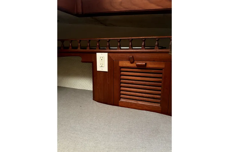 Slide: The Image of Interior of 1979 Tayana 37 sailboat with wooden cabinetry and electrical outlet. - 17