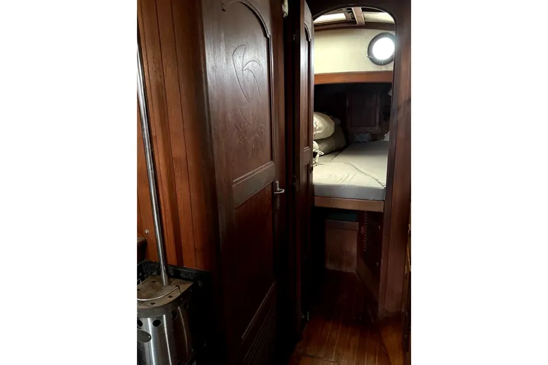 Slide: The Image of Cozy cabin interior of 1979 Tayana 37 sailboat with wooden finish and porthole. - 20