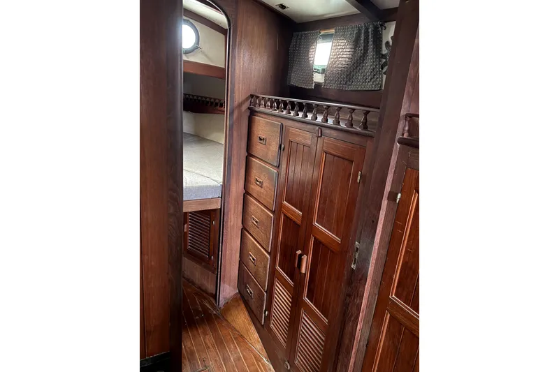 Slide: The Image of Interior of 1979 Tayana 37 sailboat with wooden cabinetry and cozy sleeping quarters. - 22