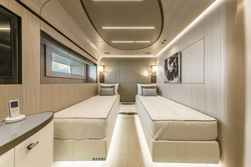 Slide: The Image of Luxurious Rossinavi Vector 50m yacht bedroom interior, featuring modern twin beds and elegant lighting. - 24