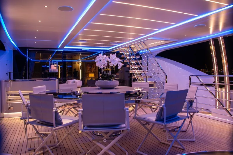 Slide: The Image of Luxurious Rossinavi Vector 50m yacht deck with elegant seating and ambient blue lighting, 2020 model. - 25