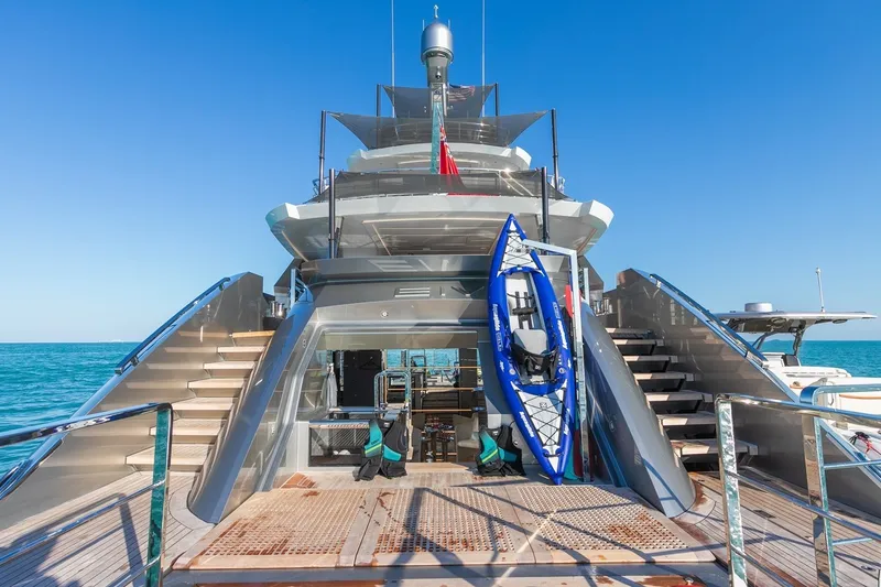 Slide: The Image of Luxurious Rossinavi Vector 50m yacht, 2020 model, with kayak on deck, against clear blue sea. - 40