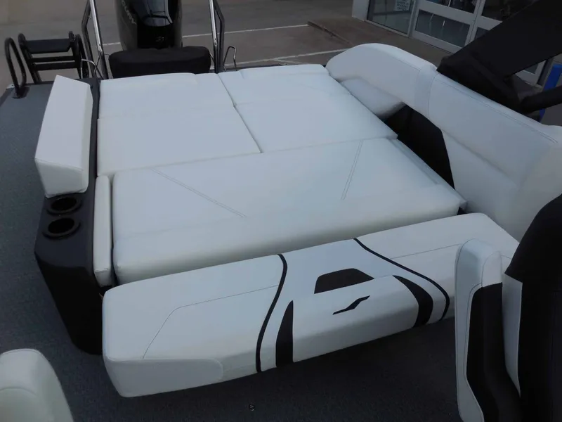 Slide: The Image of The image shows the spacious white lounge seating of an Evotti 725 CS Arch Tri Toon boat. - 16