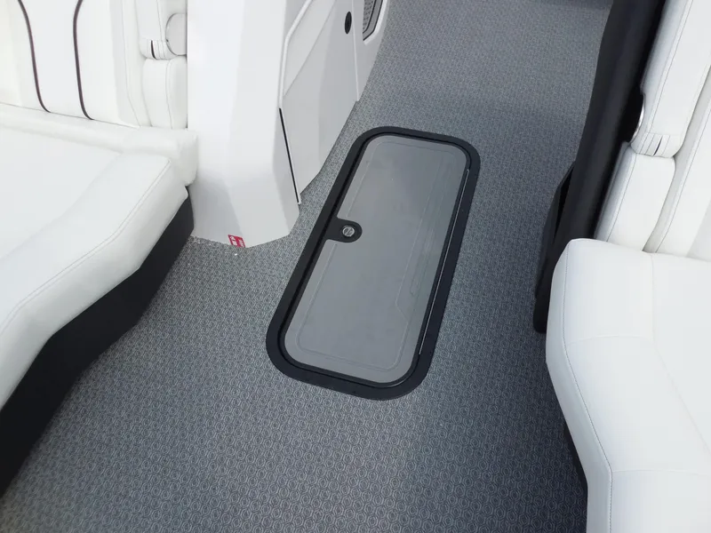 Slide: The Image of Interior of the Evotti 725 CS Arch Tri Toon with gray carpet flooring and white seating. - 18