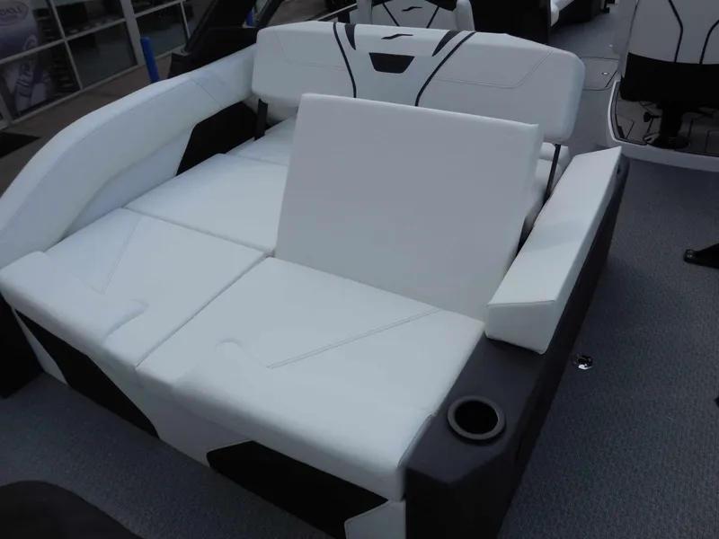 Slide: The Image of The image shows a luxurious white seating area on a boat with black accents and a cup holder. - 15