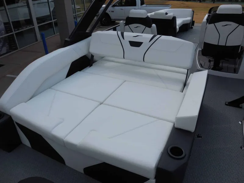 Slide: The Image of The image shows the luxurious white seating and lounging area of a 2027 Evotti 725 CS Arch Tri Toon. - 14