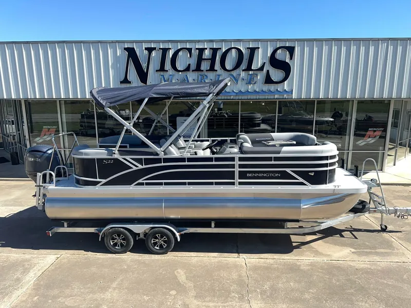 The Image of Bennington 22 SSR pontoon boat from 2027 parked on a trailer in front of a building. - 0