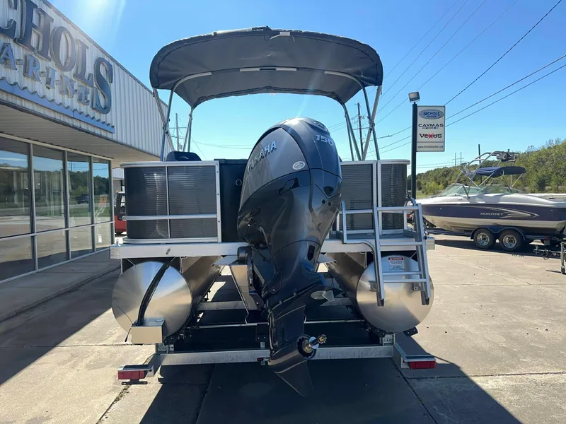 Slide: The Image of A Bennington 22 SFC pontoon boat with a Yamaha outboard motor sits on a trailer outside a building. - 3