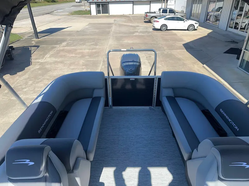 Slide: The Image of The image shows the interior of a Bennington 22 SFC pontoon boat with gray seating. - 11