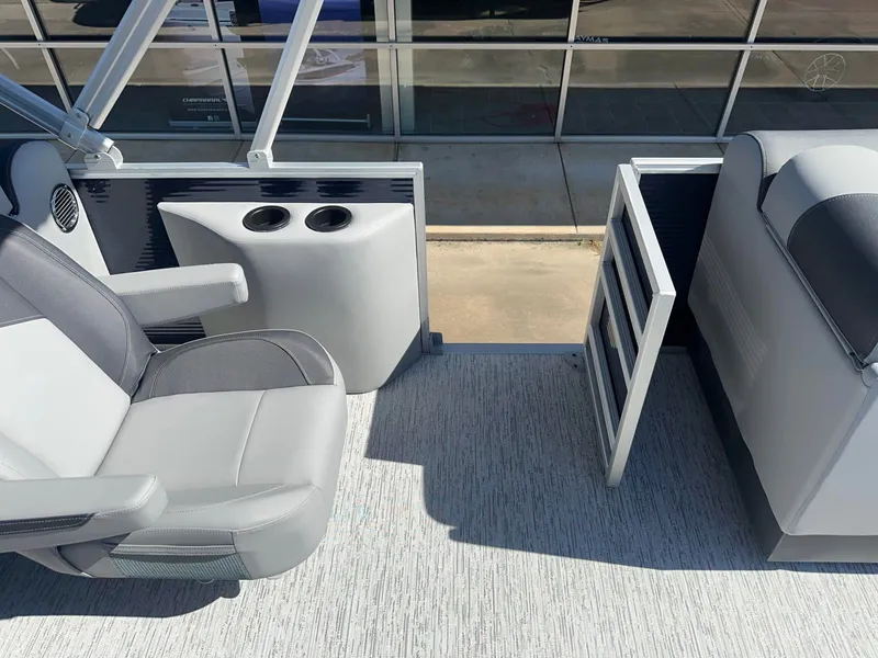 Slide: The Image of Interior of a 2027 Bennington 22 SFC with gray seating and cup holders. - 9