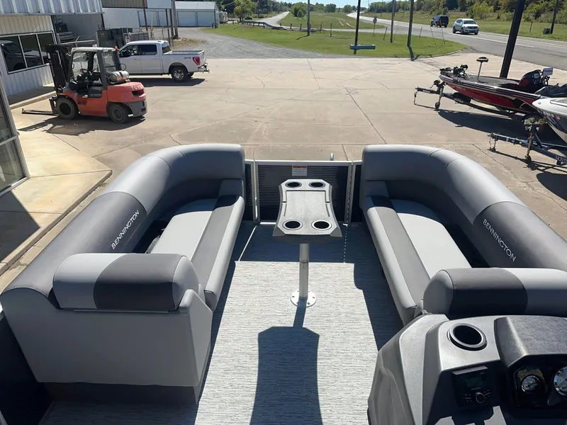 Slide: The Image of The image shows the interior of a Bennington 22 SFC pontoon boat with gray seating and a table. - 8