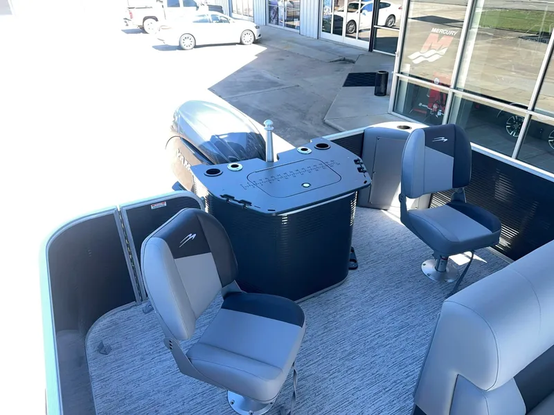 Slide: The Image of The image shows the deck of a Bennington 22 SFC boat with gray seats and a helm station. - 11