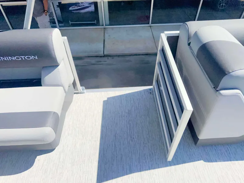 Slide: The Image of The image shows the deck of a Bennington 22 SFC boat with gray seating. - 9