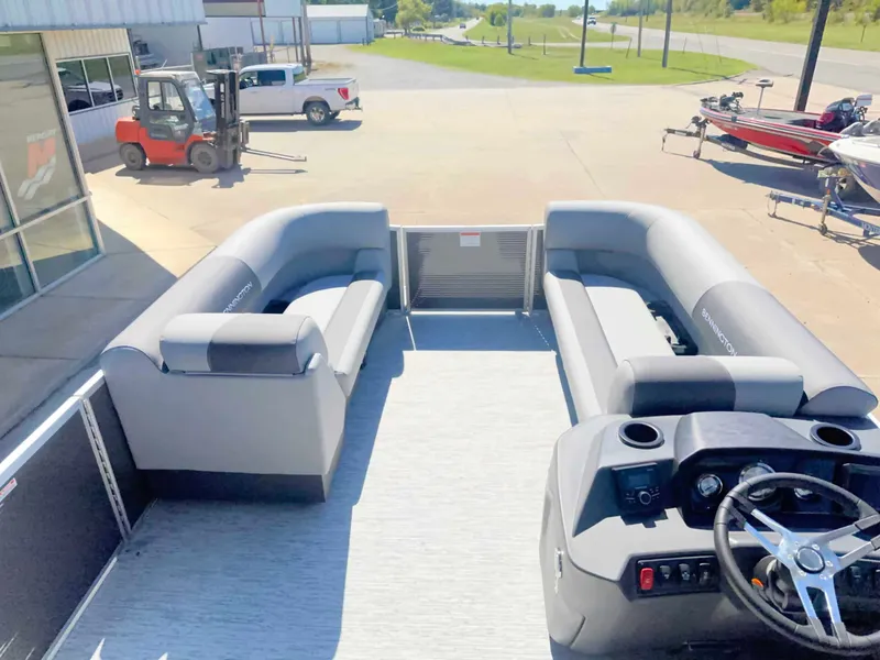 Slide: The Image of The image shows the deck of a Bennington 22 SFC pontoon boat with gray seating and a helm. - 8