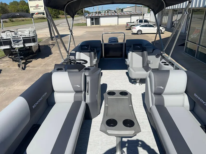 Slide: The Image of The image shows the interior of a Bennington 22 SFC pontoon boat with gray and white seating. - 10