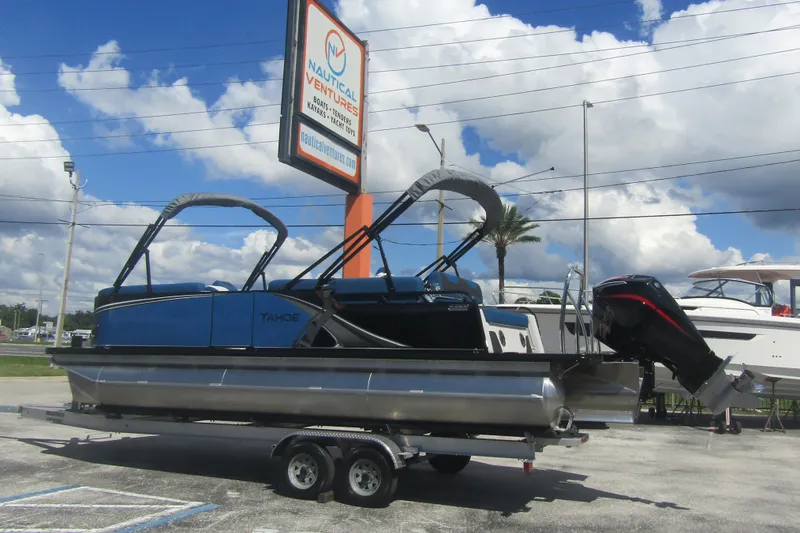 Slide: The Image of 2026 Tahoe Pontoon LTZ Cruise Rear Bench 23 on trailer at dealership. - 3