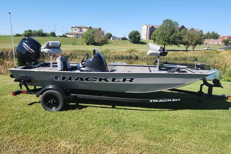 The Image of 2027 Tracker Pro 170 boat on trailer, parked on grass with scenic background. - 0