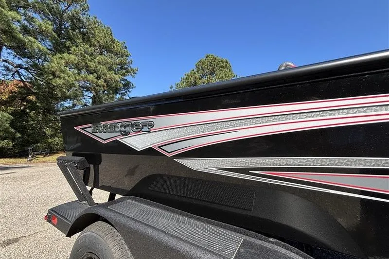 Slide: The Image of 2026 Ranger VS1882SC Angler boat with sleek black and red design, parked outdoors. - 37