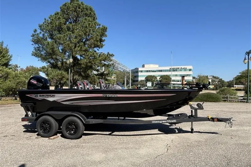 Slide: The Image of 2026 Ranger VS1882SC Angler boat on trailer, parked outdoors with trees and buildings in background. - 8