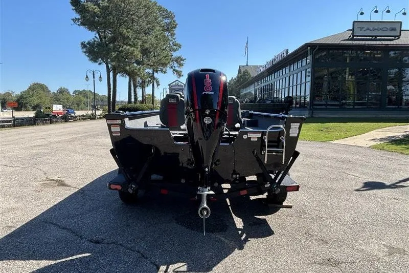 Slide: The Image of 2026 Ranger VS1882SC Angler boat with powerful outboard motor, parked outdoors. - 12