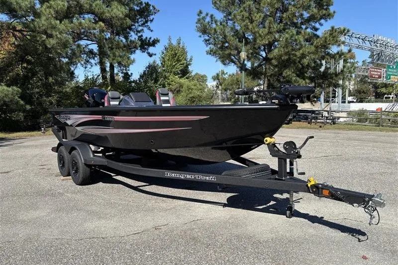 Slide: The Image of 2026 Ranger VS1882SC Angler boat on trailer, parked outdoors with trees in background. - 7