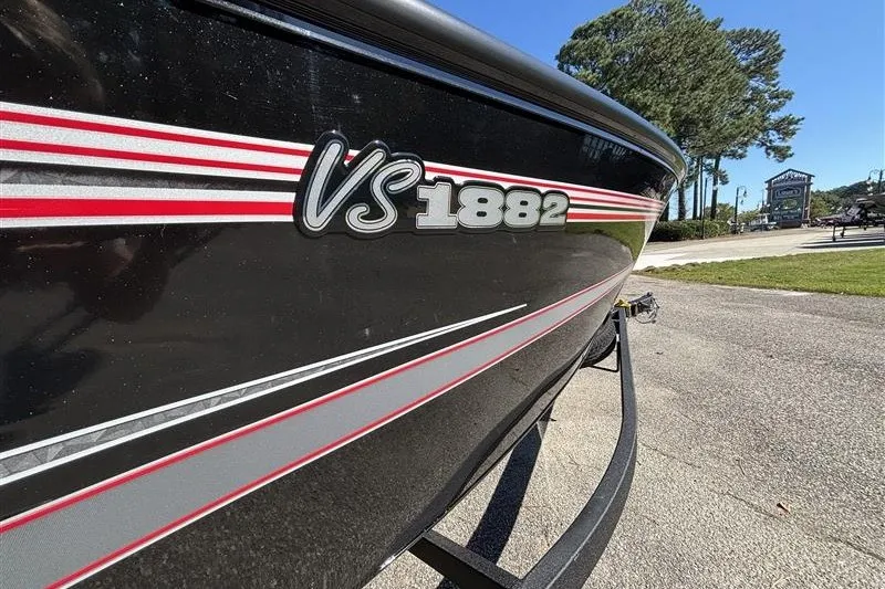 Slide: The Image of 2026 Ranger VS1882SC Angler boat with sleek black and red design, parked outdoors. - 38
