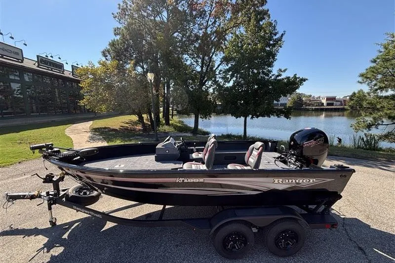Slide: The Image of 2026 Ranger VS1882SC Angler boat on trailer by a scenic lake. - 1