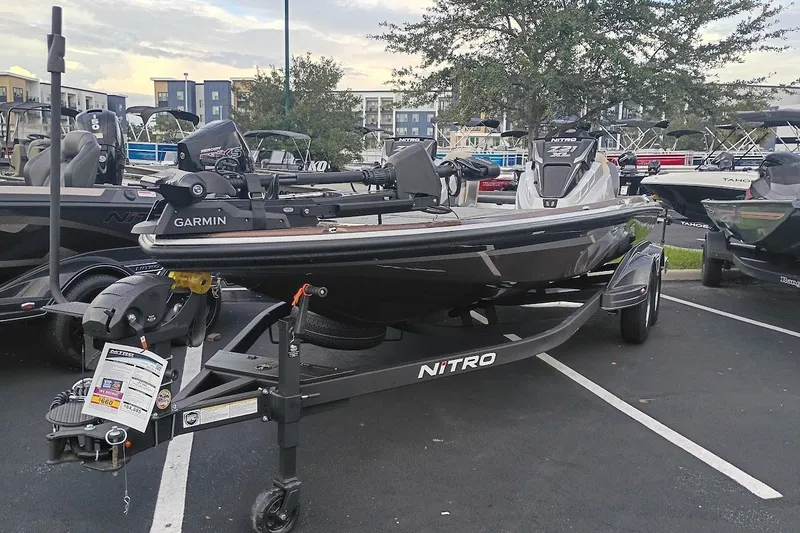 Slide: The Image of 2027 Nitro Z21 XL Pro fishing boat on trailer in parking lot. - 1