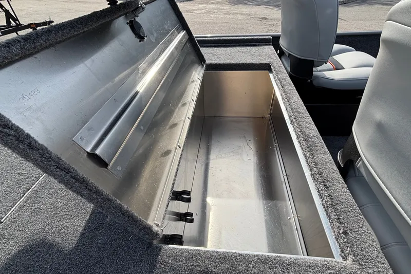Slide: The Image of Open storage compartment in 2027 Tracker Bass Tracker Classic Limited boat interior. - 14