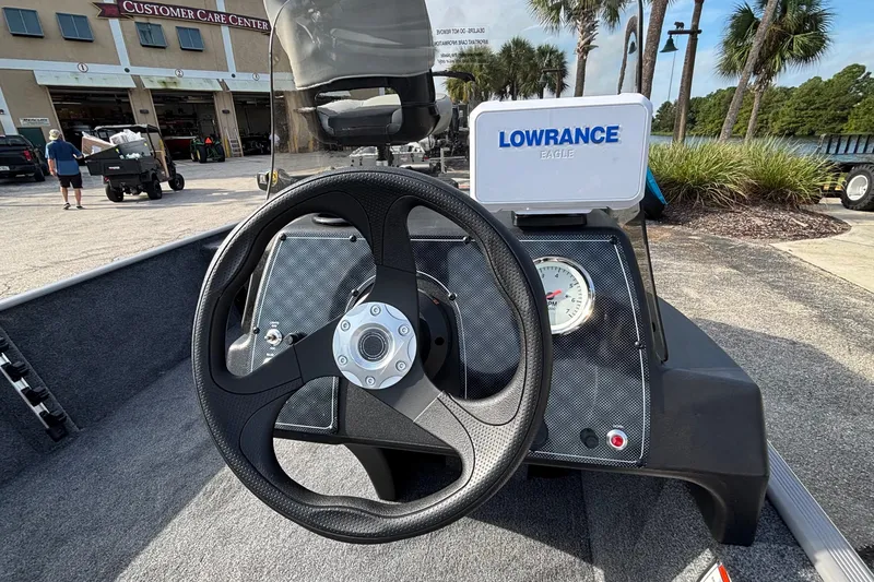 Slide: The Image of 2027 Tracker Bass Tracker Classic Limited boat dashboard with steering wheel and Lowrance Eagle device. - 13